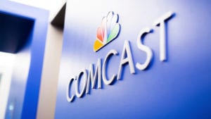 The Comcast logo on a wall.
