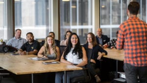 An audience listens to a speaker at a LIFT Labs event.